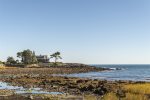 A view of the home from Shore Road exhibiting the peninsula on which it is located.
